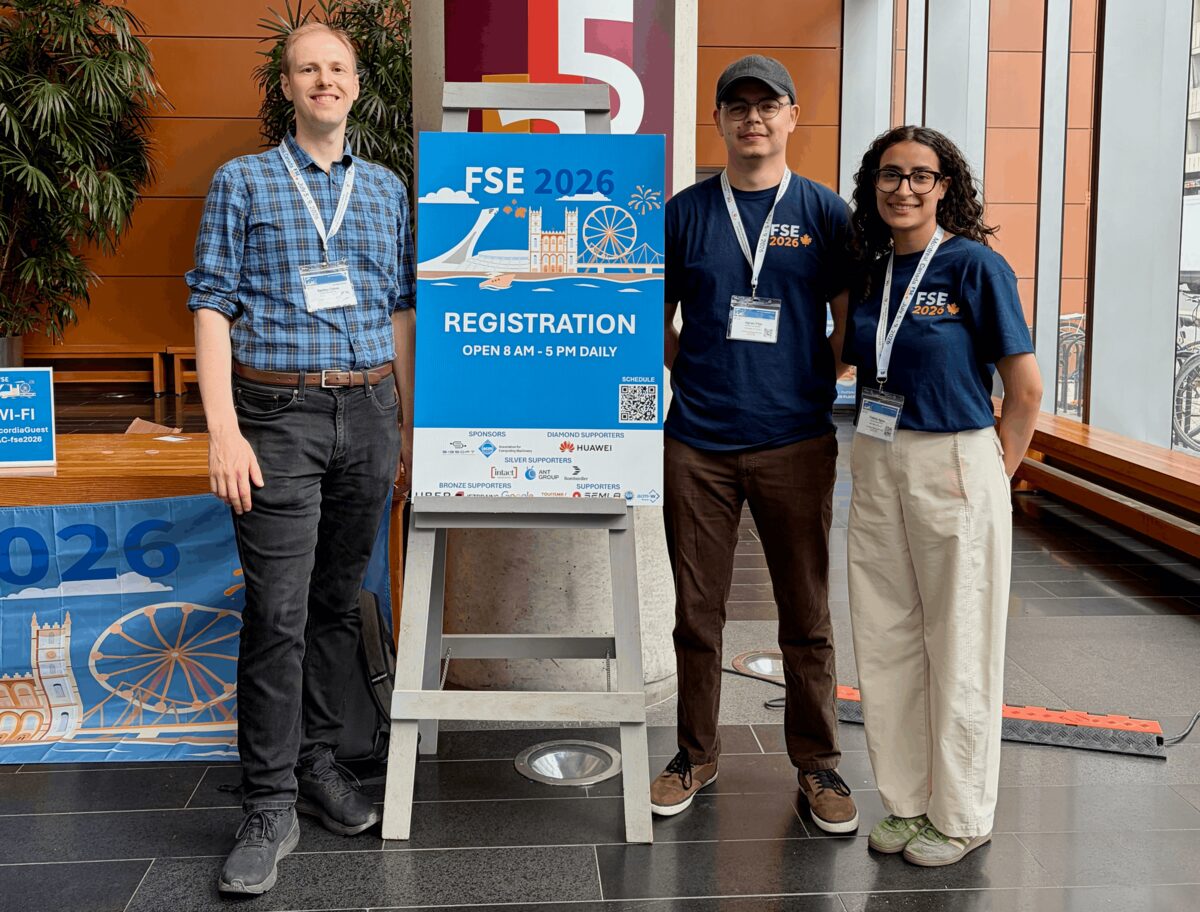 Bentley Oakes, Kérian Fiter, and Fatima Aguel standing beside the FSE 2026 registration sign in Montréal.