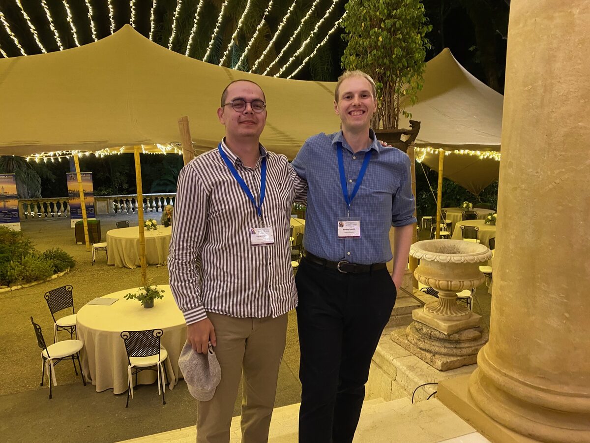 Bentley Oakes and Kérian Fiter under a tent of string lights at the MODELS 2026 banquet.